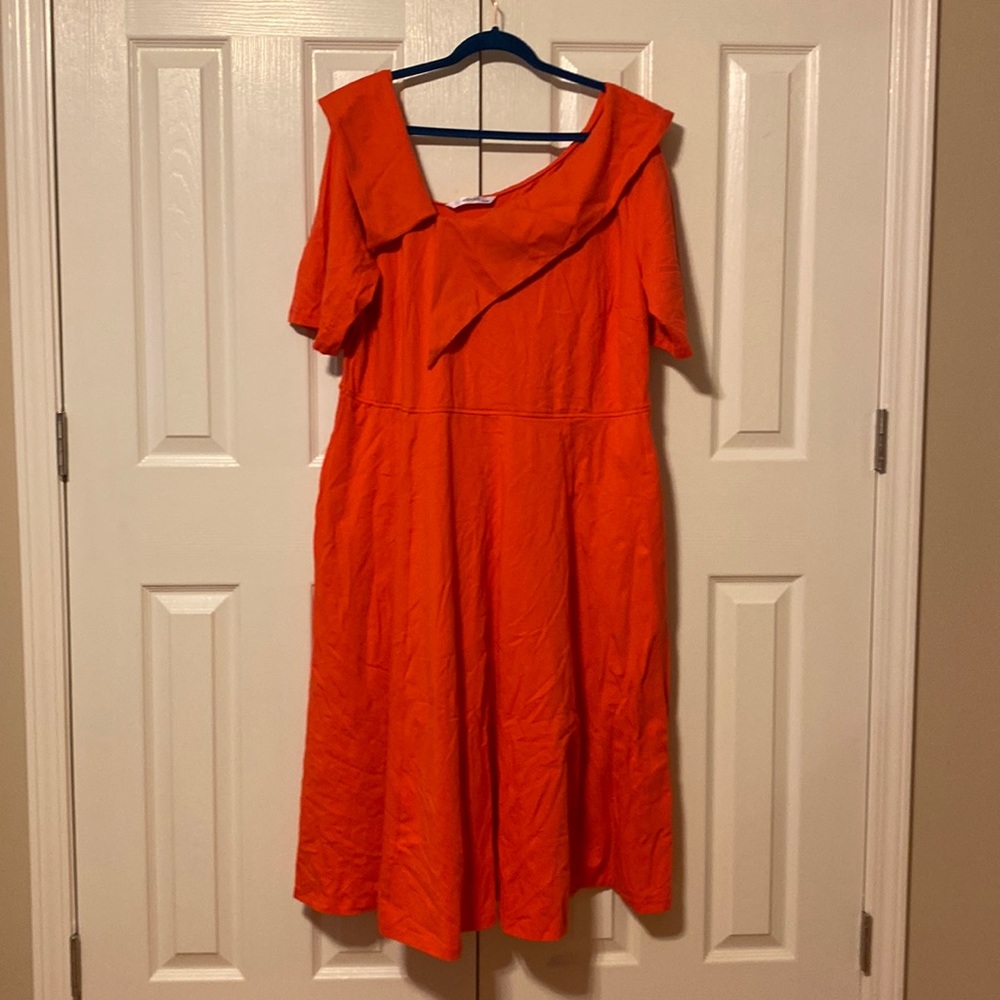 Coral colored asymmetrical neck line.